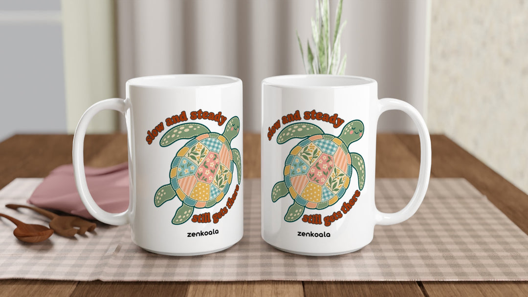 Two Slow and Steady Turtle 15oz mugs on a table, showing both sides of the design, Zen Koala Australia