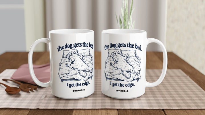 Two The Dog Gets the Bed 15oz mugs on a table, showing both sides of the design, Zen Koala Australia