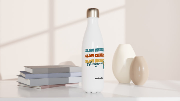 Slow Christmas Thongs On water bottle beside books and vases, Zen Koala Australia