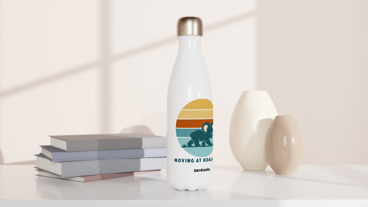 Moving at Koala Pace water bottle beside books and vases, Zen Koala Australia