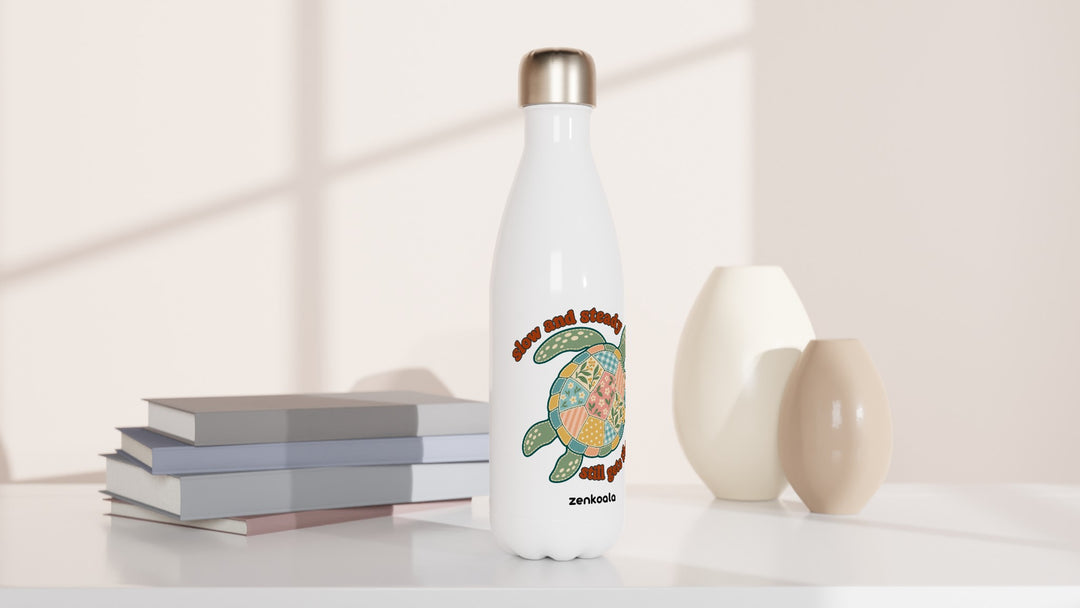 Slow and Steady Turtle water bottle beside books and vases, Zen Koala Australia