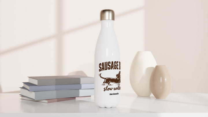 Sausage Dog Slow Walker water bottle beside books and vases, Zen Koala Australia