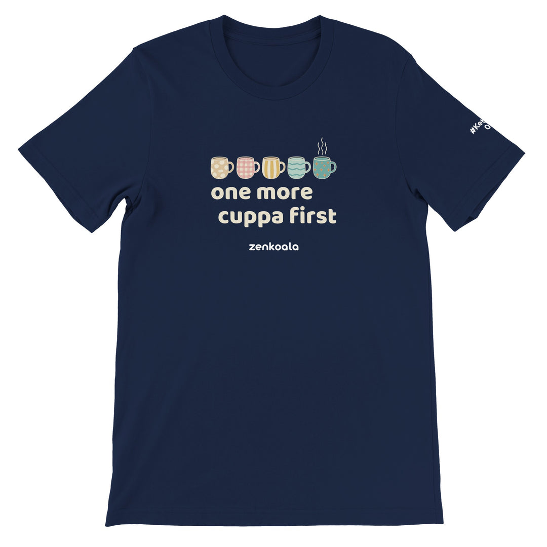 One More Cuppa First feel-good tee in navy: a row of patterned cuppas, one still steaming, Zen Koala Australia