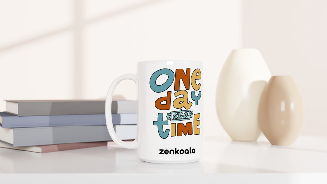 One Day at a Time 15oz mug beside books and vases, Zen Koala Australia