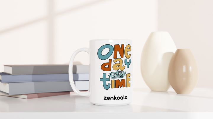 One Day at a Time 15oz mug beside books and vases, Zen Koala Australia