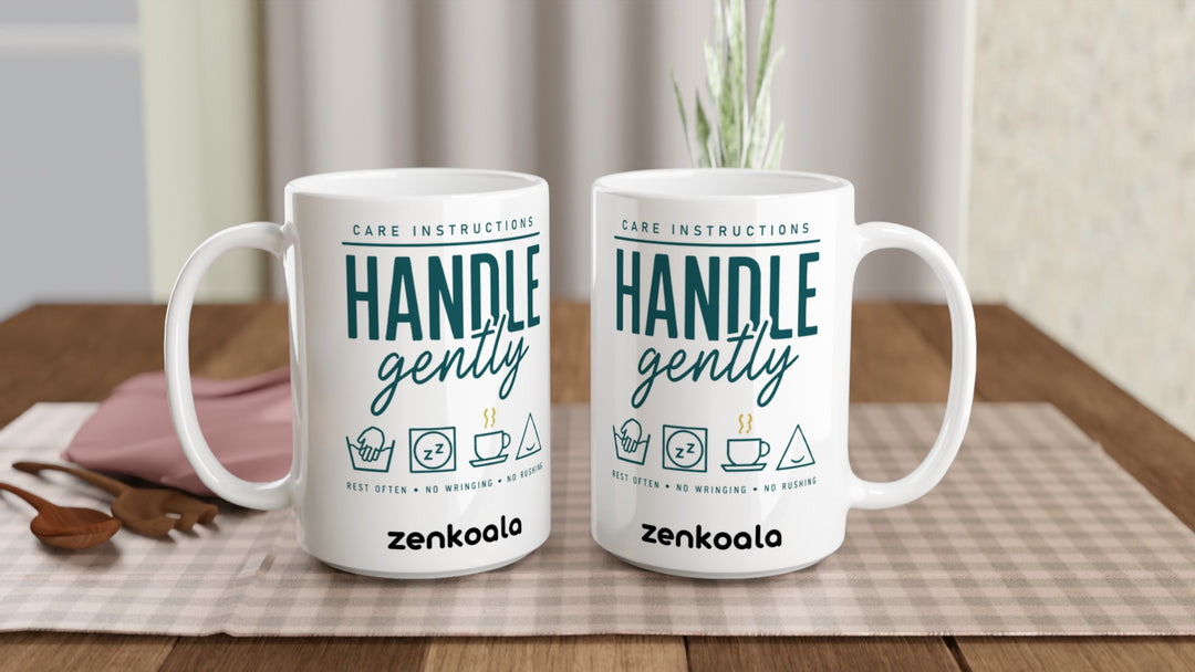 Two Handle Gently Care Instructions 15oz mugs on a table, showing both sides of the design, Zen Koala Australia