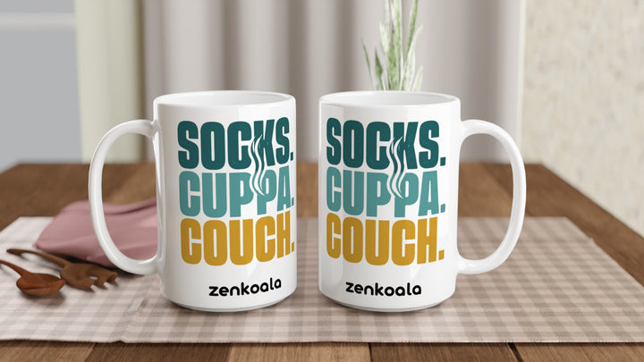Two Socks Cuppa Couch 15oz mugs on a table, showing both sides of the design, Zen Koala Australia