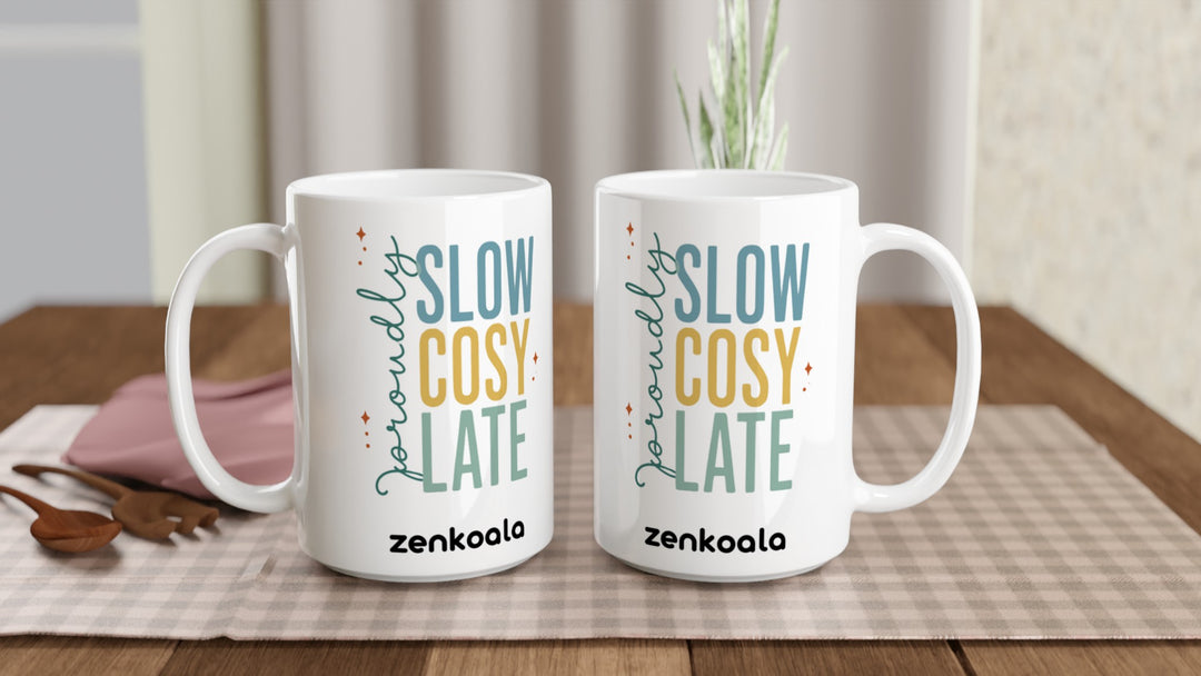 Two Proudly Slow Cosy Late 15oz mugs on a table, showing both sides of the design, Zen Koala Australia