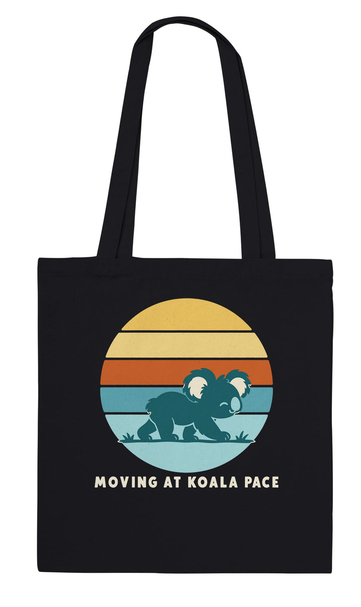 Moving at Koala Pace feel-good tote bag in black: a koala strolling across a retro sunset, Zen Koala Australia