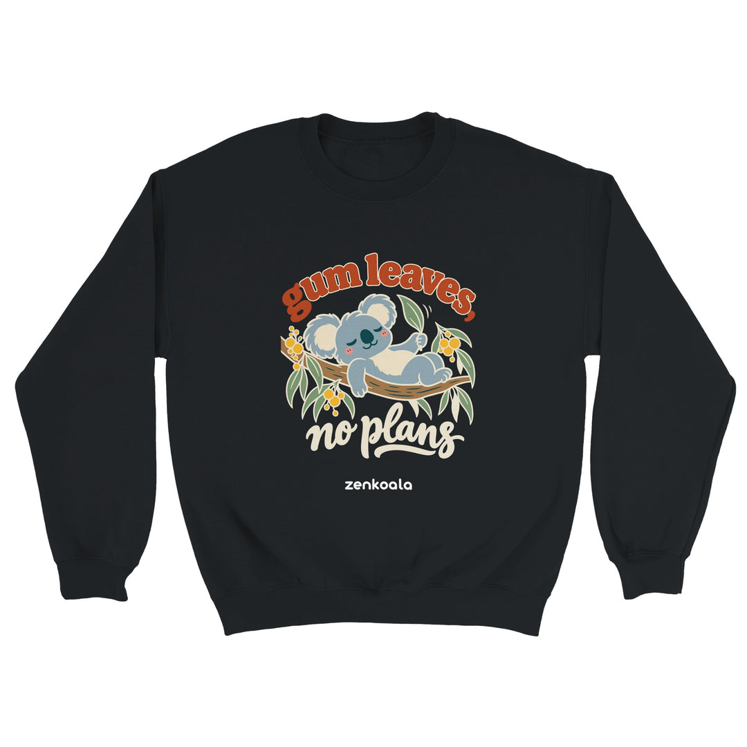 Gum Leaves No Plans feel-good sweatshirt in black: a koala lazing on a gum branch among wattle, Zen Koala Australia
