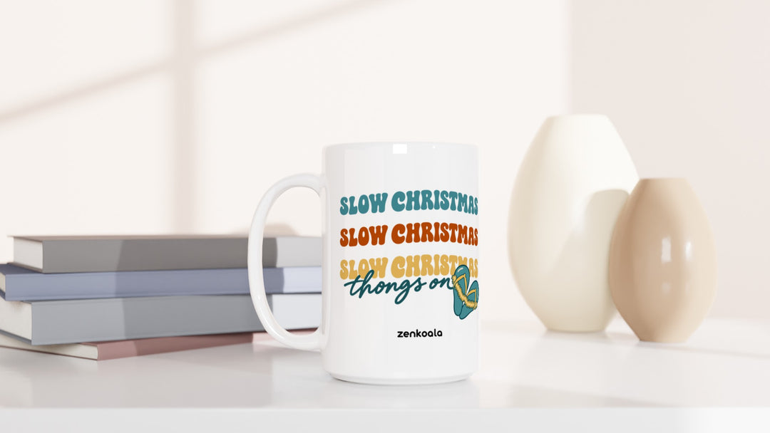 Slow Christmas Thongs On 15oz mug beside books and vases, Zen Koala Australia