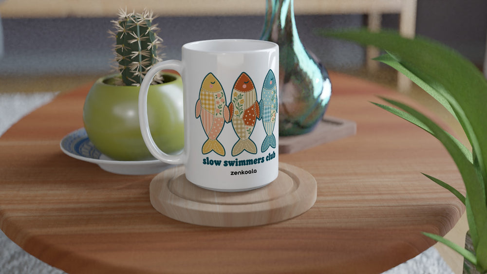 Slow Swimmers Club 15oz mug on a wooden table with a cactus, Zen Koala Australia