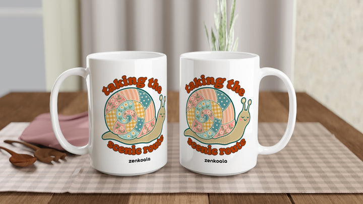 Two Taking the Scenic Route Snail 15oz mugs on a table, showing both sides of the design, Zen Koala Australia