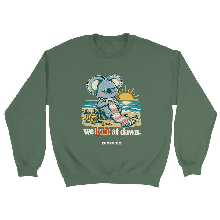 We Knit at Dawn feel-good sweatshirt in military green: a koala knitting on the beach, Zen Koala Australia