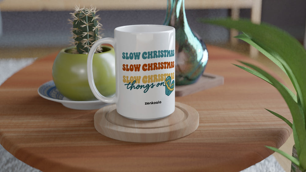 Slow Christmas Thongs On 15oz mug on a wooden table with a cactus, Zen Koala Australia