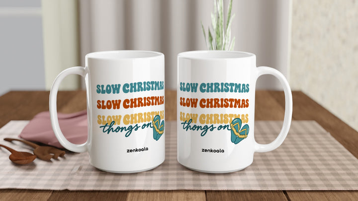 Two Slow Christmas Thongs On 15oz mugs on a table, showing both sides of the design, Zen Koala Australia