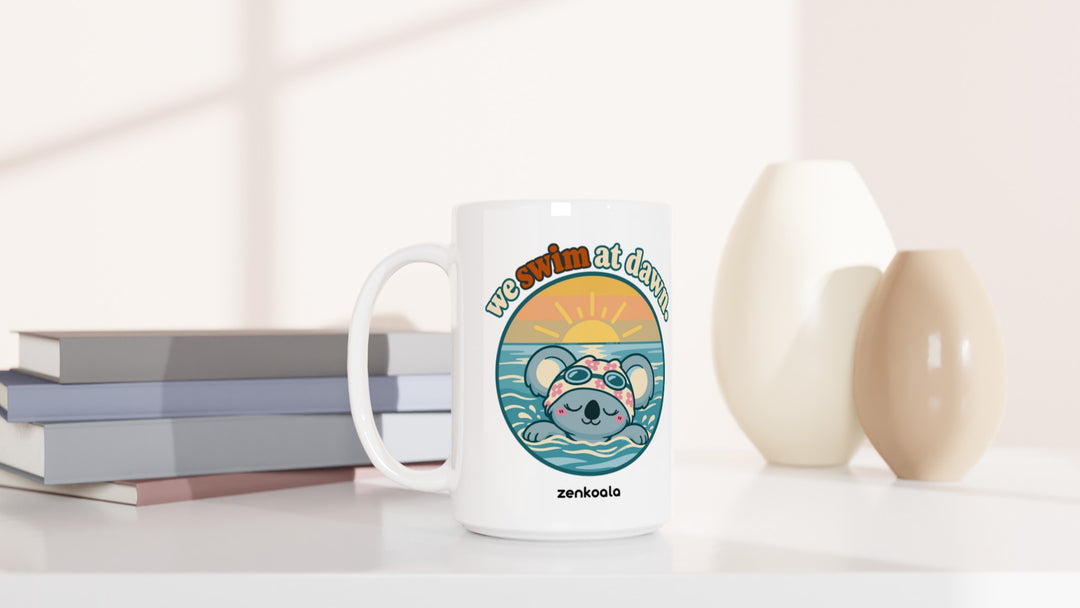 We Swim at Dawn 15oz mug beside books and vases, Zen Koala Australia