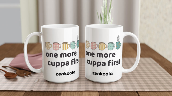 Two One More Cuppa First 15oz mugs on a table, showing both sides of the design, Zen Koala Australia