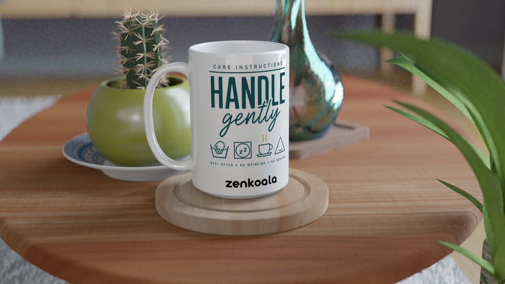 Handle Gently Care Instructions 15oz mug on a wooden table with a cactus, Zen Koala Australia