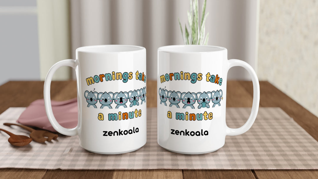 Two Mornings Take a Minute 15oz mugs on a table, showing both sides of the design, Zen Koala Australia