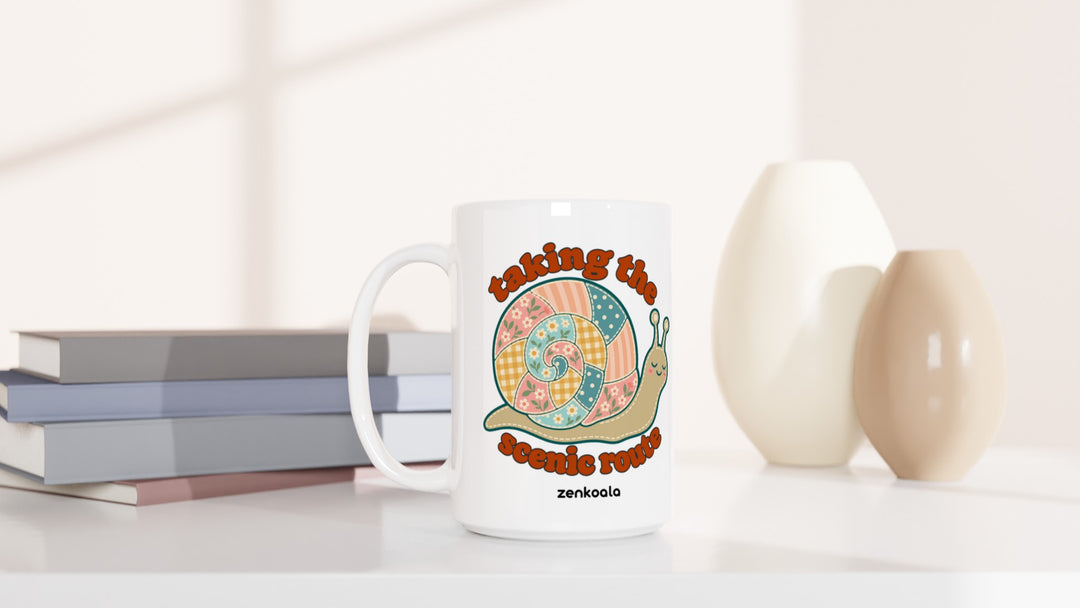 Taking the Scenic Route Snail 15oz mug beside books and vases, Zen Koala Australia