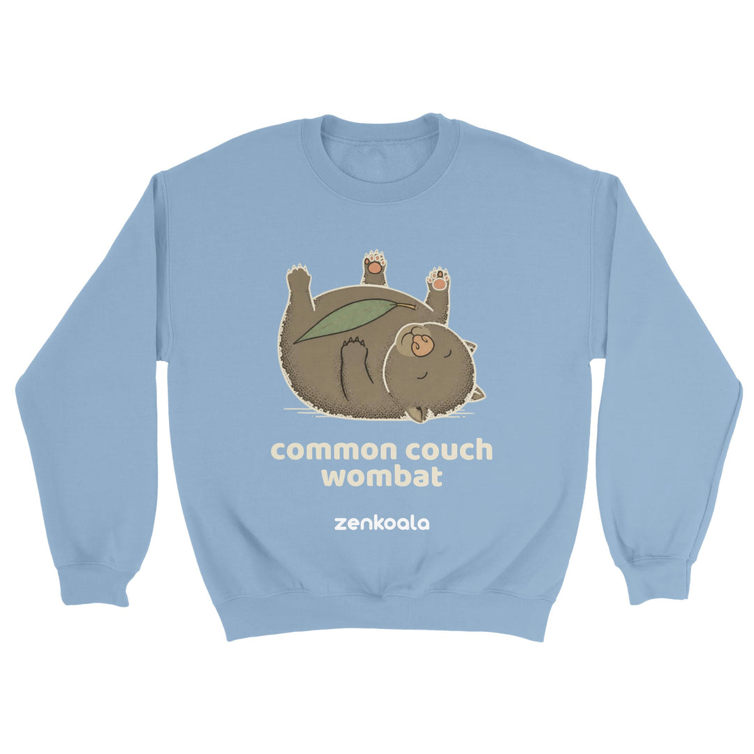 Common Couch Wombat feel-good sweatshirt in light blue — a wombat flat out on its back with a gum leaf, Zen Koala Australia