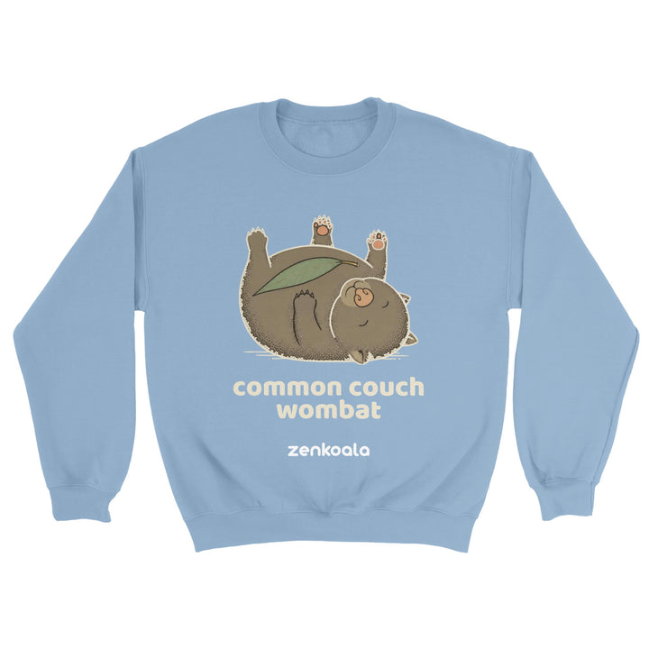 Common Couch Wombat feel-good sweatshirt in light blue — a wombat flat out on its back with a gum leaf, Zen Koala Australia