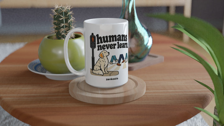 Humans Never Learn 15oz mug on a wooden table with a cactus, Zen Koala Australia