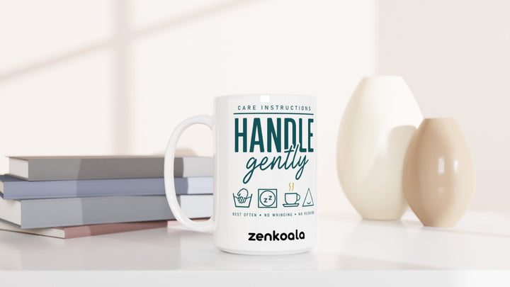 Handle Gently Care Instructions 15oz mug beside books and vases, Zen Koala Australia