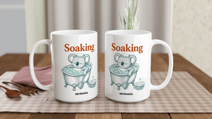 Two Soaking Koala Bath 15oz mugs on a table, showing both sides of the design, Zen Koala Australia