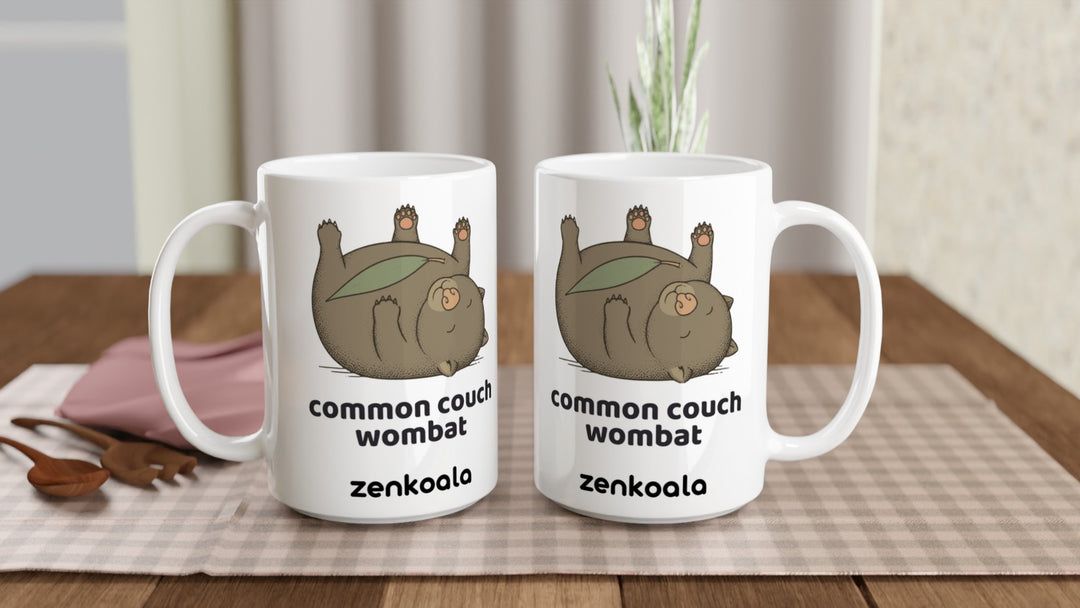 Two Common Couch Wombat 15oz mugs on a table, showing both sides of the design, Zen Koala Australia