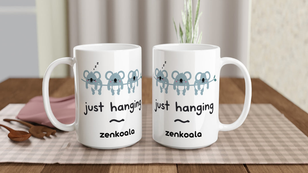 Two Just Hanging 15oz mugs on a table, showing both sides of the design, Zen Koala Australia
