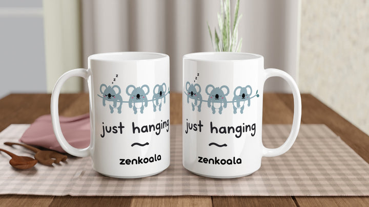 Two Just Hanging 15oz mugs on a table, showing both sides of the design, Zen Koala Australia