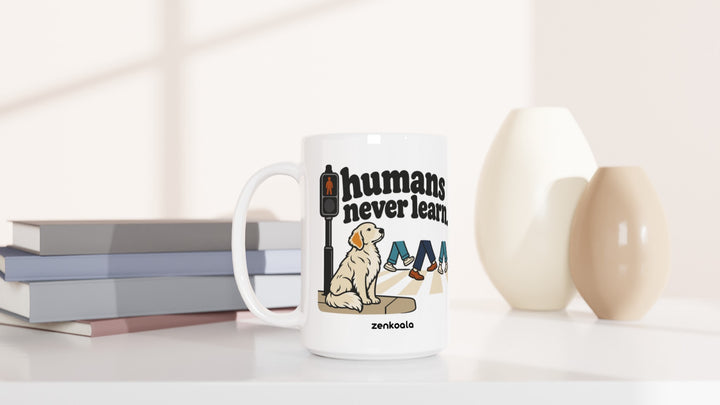 Humans Never Learn 15oz mug beside books and vases, Zen Koala Australia